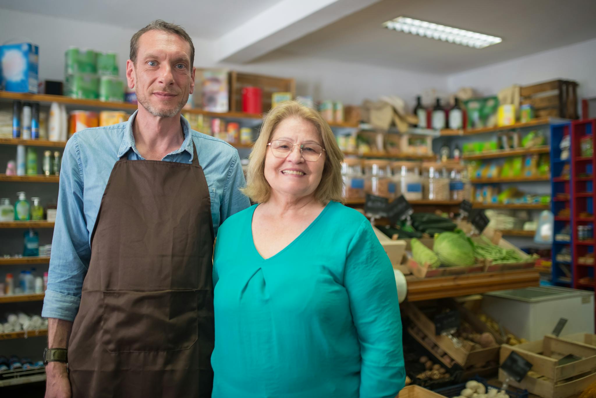 Friendly couple in a cozy organic store, highlighting community business.