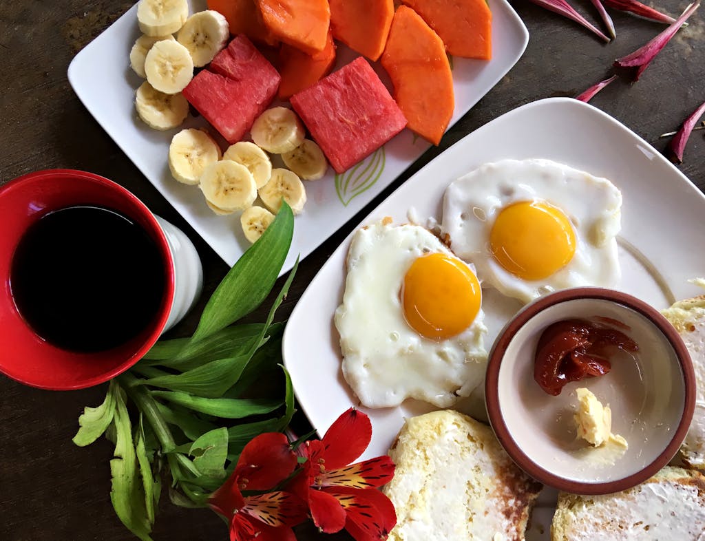 Healthy breakfast featuring eggs, fruits, and coffee arranged beautifully for a vibrant start.