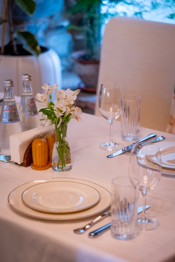 A well-arranged table setting in a Mtskheta restaurant featuring fine dinnerware and floral centerpiece.