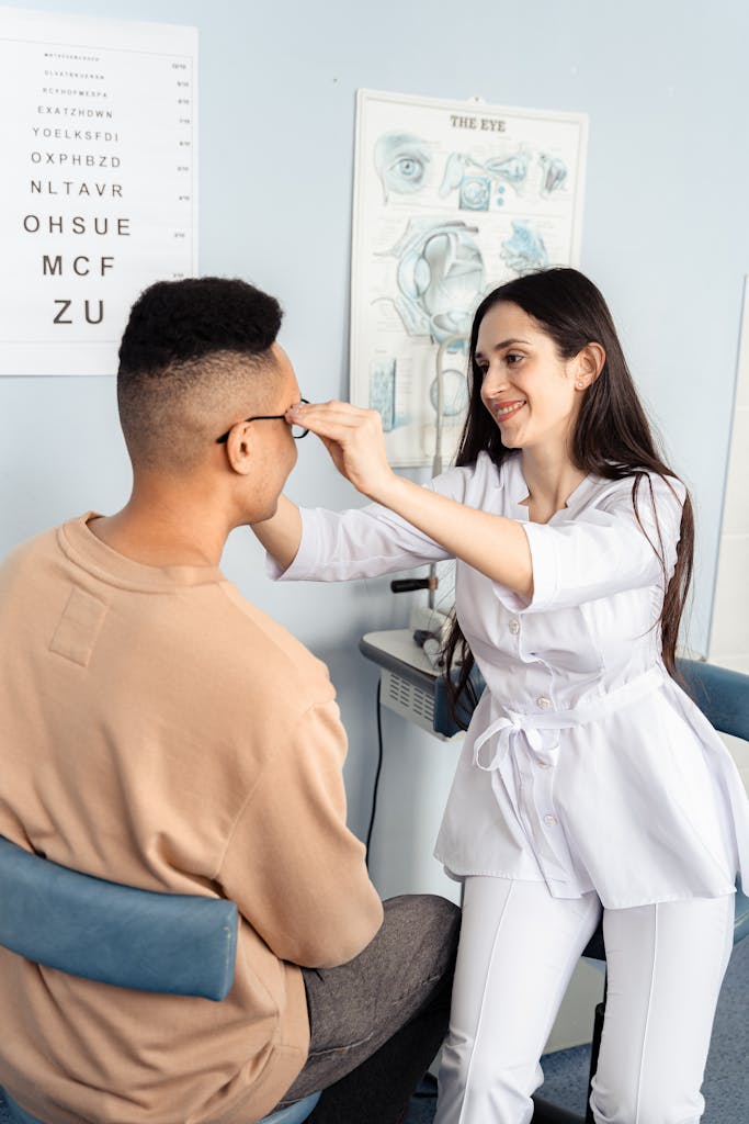 Female optometrist in clinic examining male patient's vision.